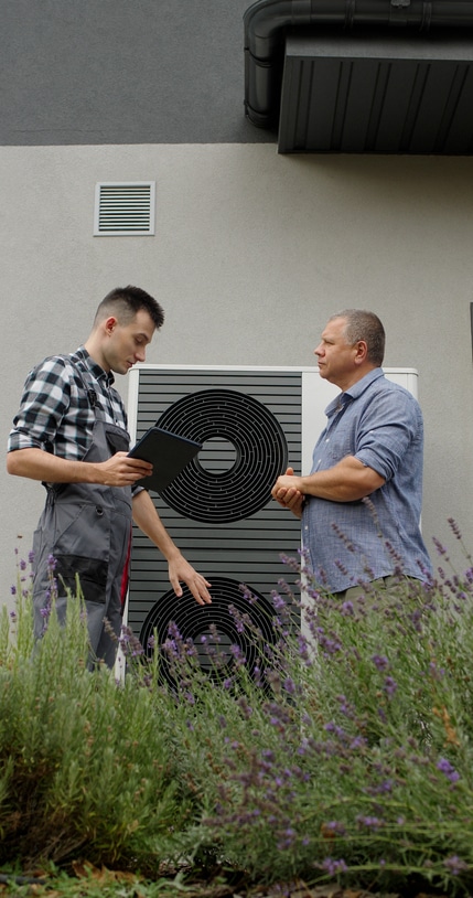 A professional advising a client about heating and cooling services.